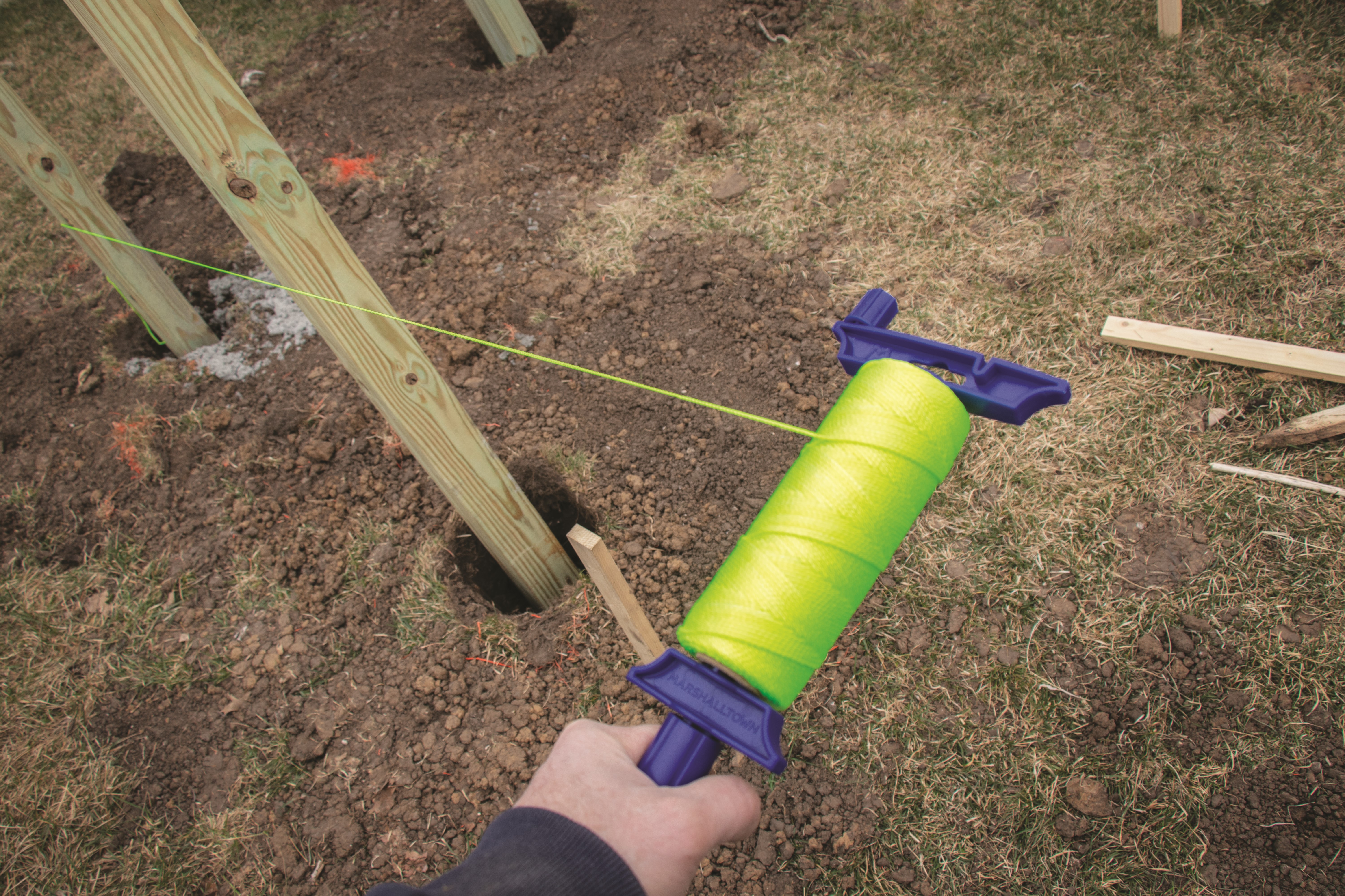 man stringing mason's line with the refillable mason's line winder